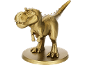 Zlatna figurica dinosaura na okrugloj bazi.