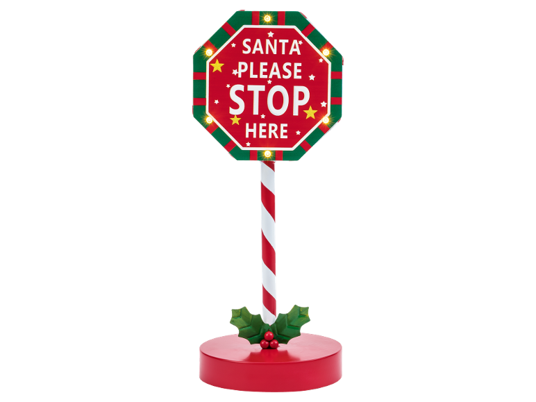 Crveno-zeleni svjetleći božićni znak „SANTA PLEASE STOP HERE“ na postolju u obliku štapa od bombona.