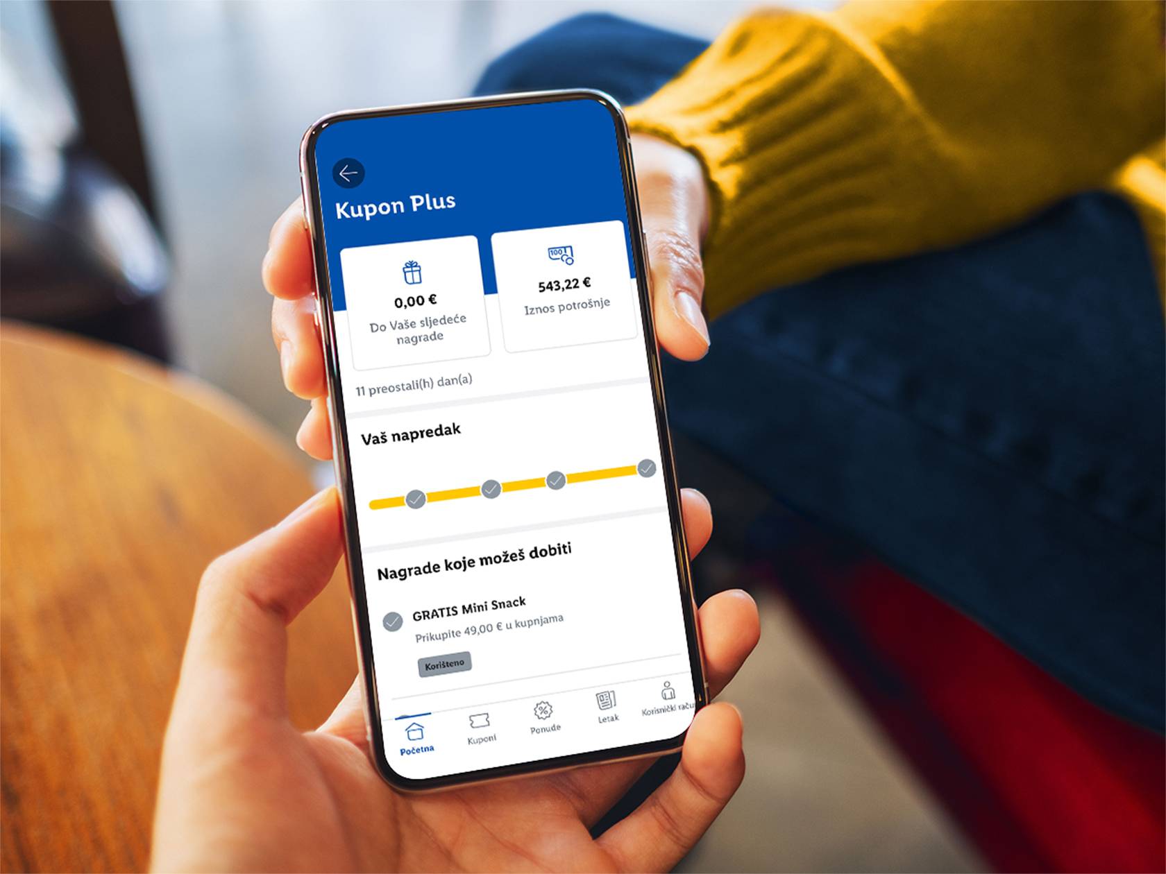 Zaslon mobilne aplikacije Kupon Plus s prikazom napretka i nagrada.