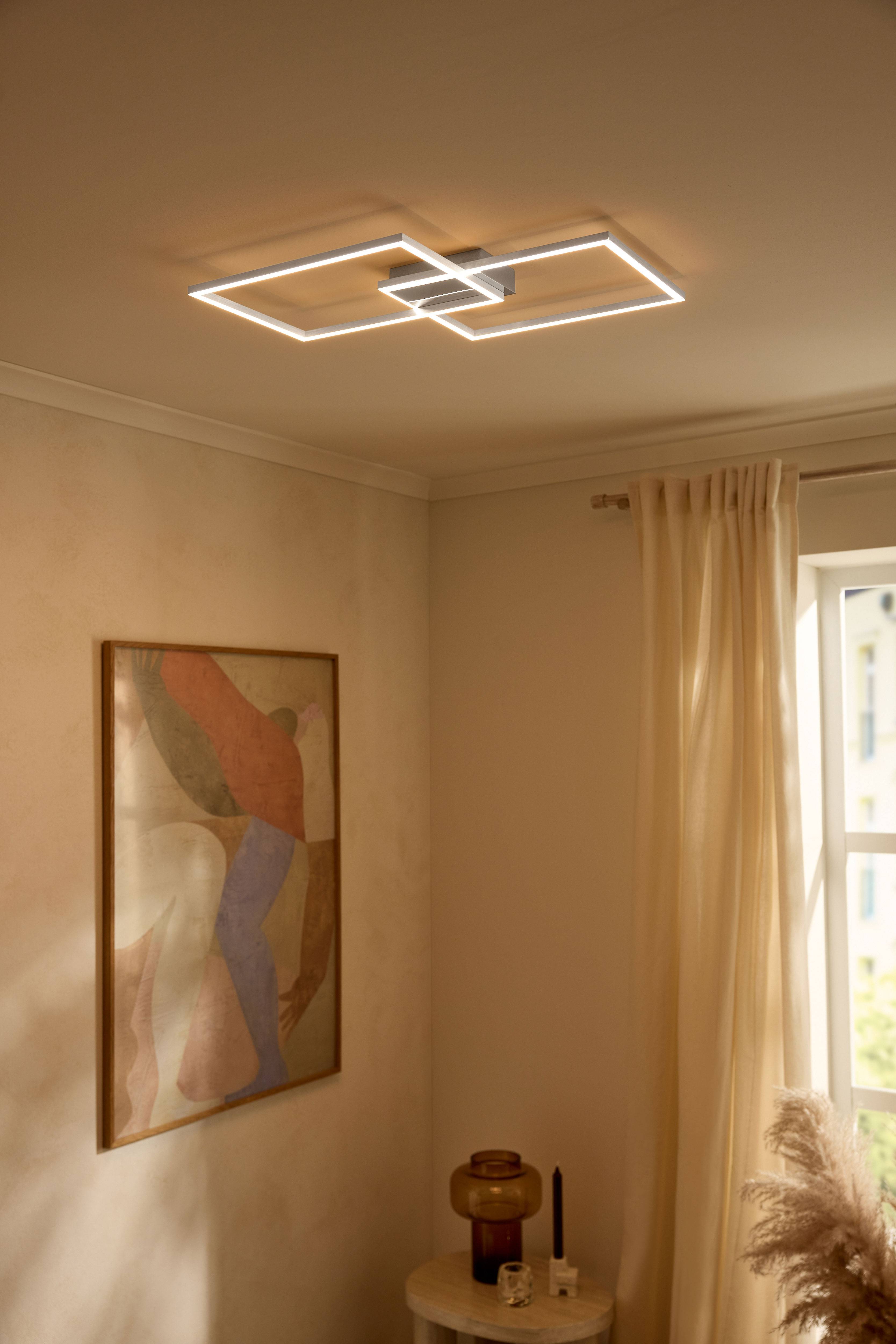 Moderna LED stropna svjetiljka pravokutnih oblika osvjetljava bež sobu.