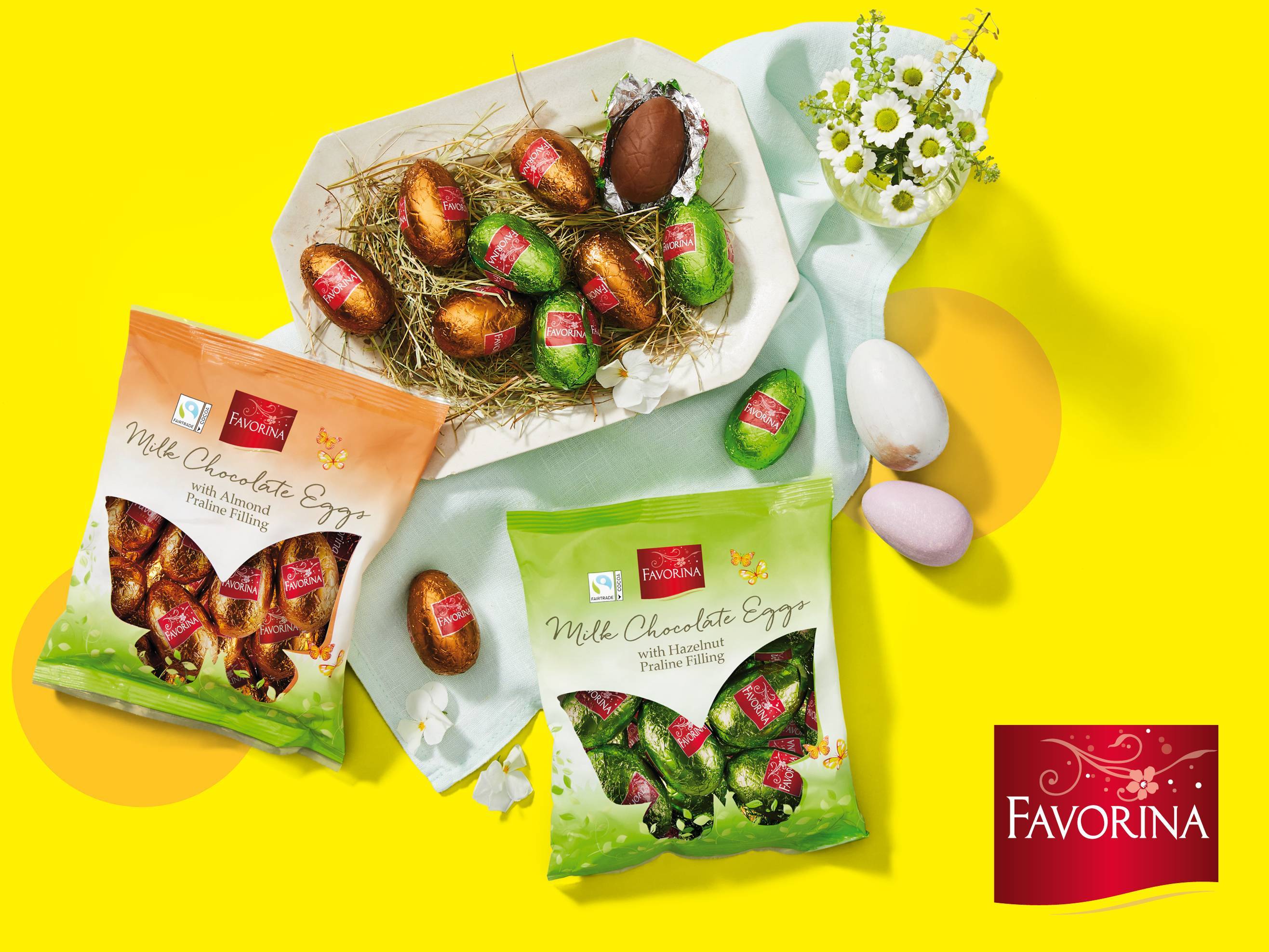 Mliječna čokoladna jaja s punjenjem od badema i lješnjaka, u pakiranjima i na pladnju.