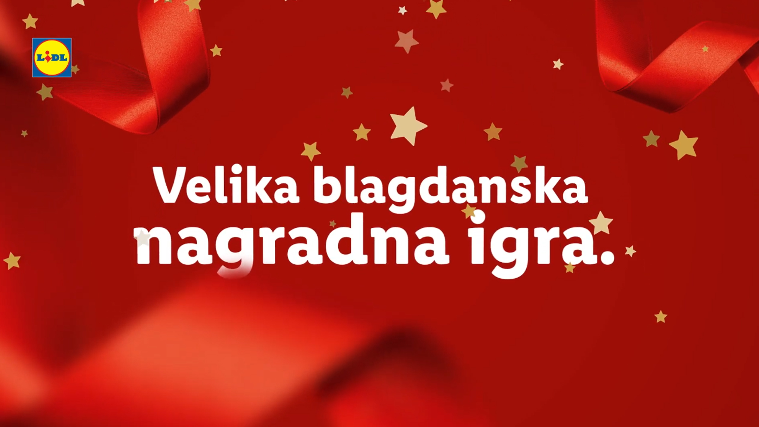 Lidl: Velika blagdanska nagradna igra na crvenoj pozadini sa zlatnim zvjezdicama i vrpcama.
